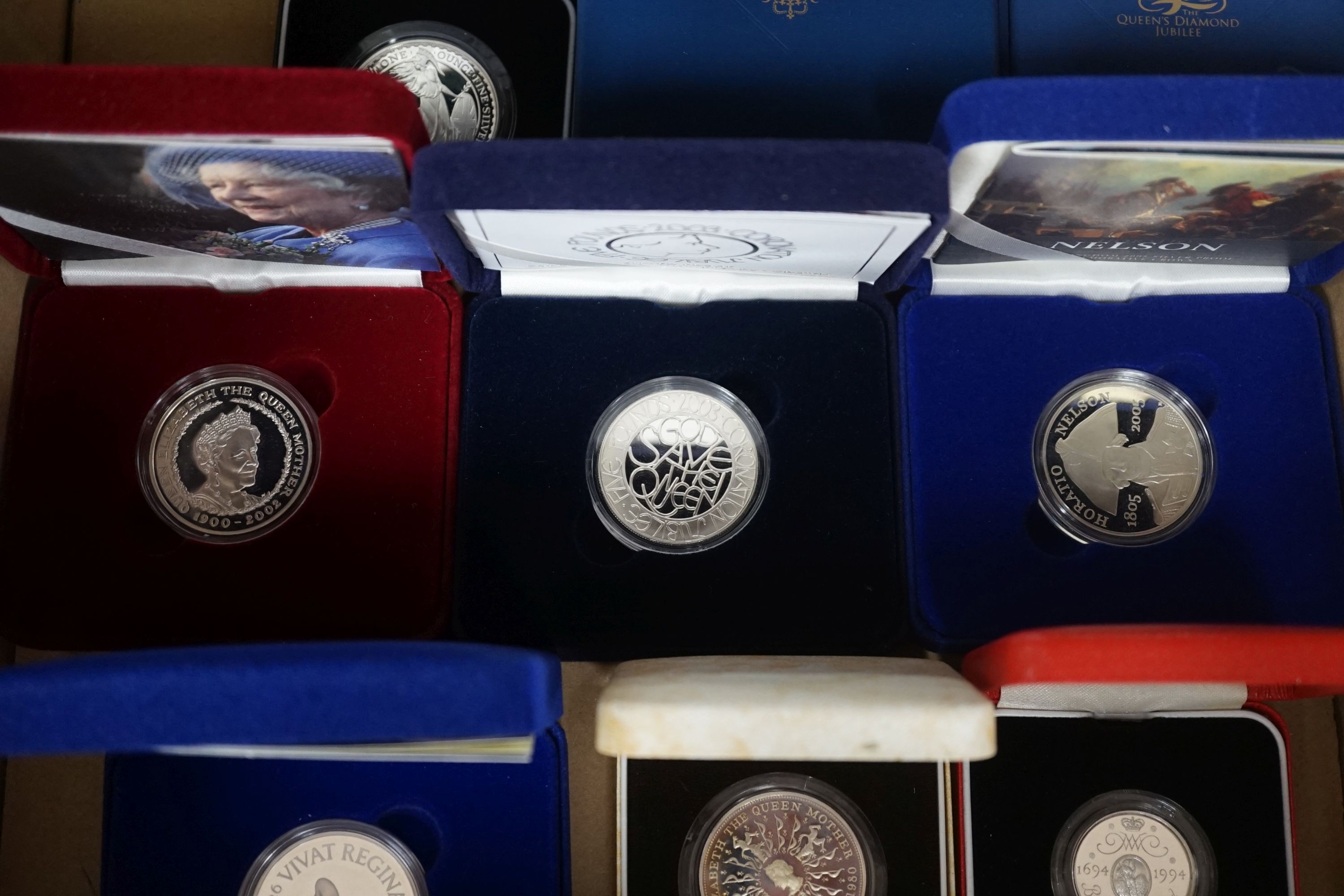 Cased Royal Mint UK silver proof coins – a 2006 1oz. ,Britannia £2, a 2012 QEII Diamond Jubilee £5, 2002 Queen Mother £5, 2003, 2005 and 2006 crowns, a 1980 Queen Mother crown and two piedfort £2 for 1994 and 2004 FIND L